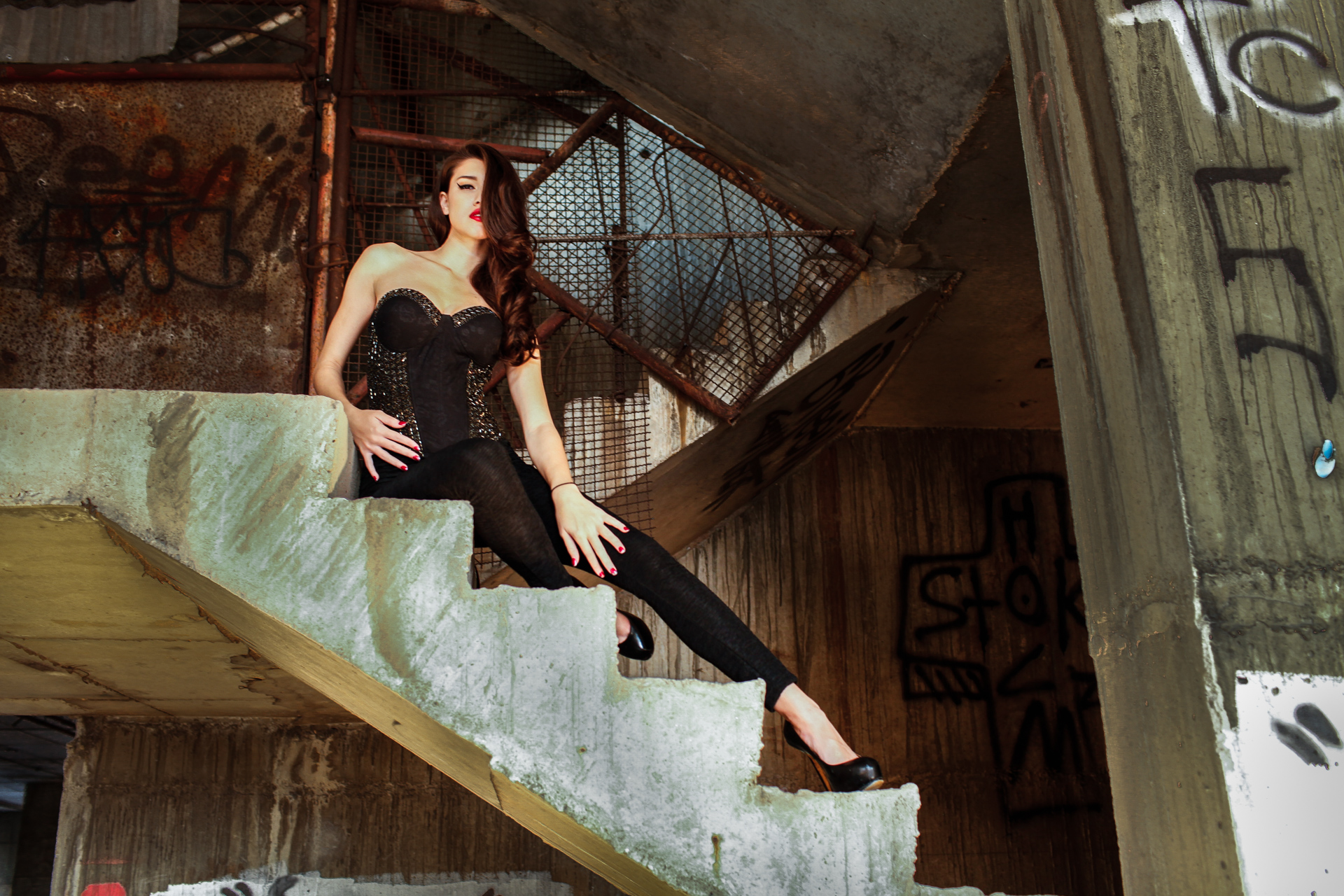 Brown haired Thai model poses in an abandoned building